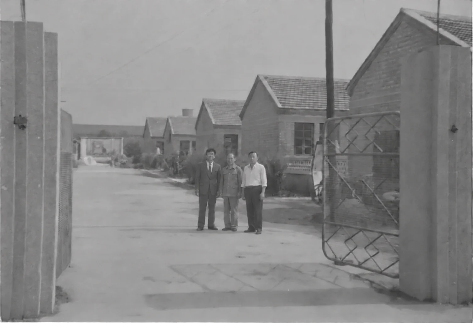 Founder Y.Q. Lee, left, with his managers at the gate of the first Baosheng workshop, 1952