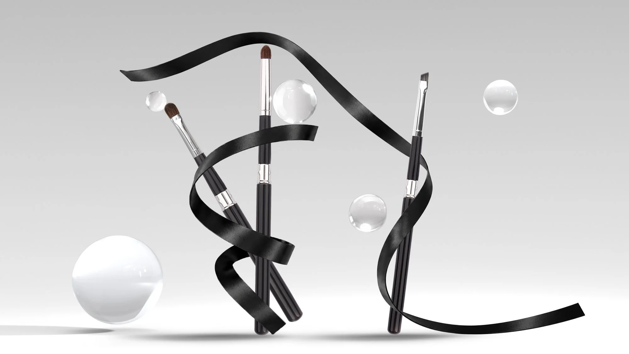 Three Baosheng brushes standing among glass spheres and black ribbon