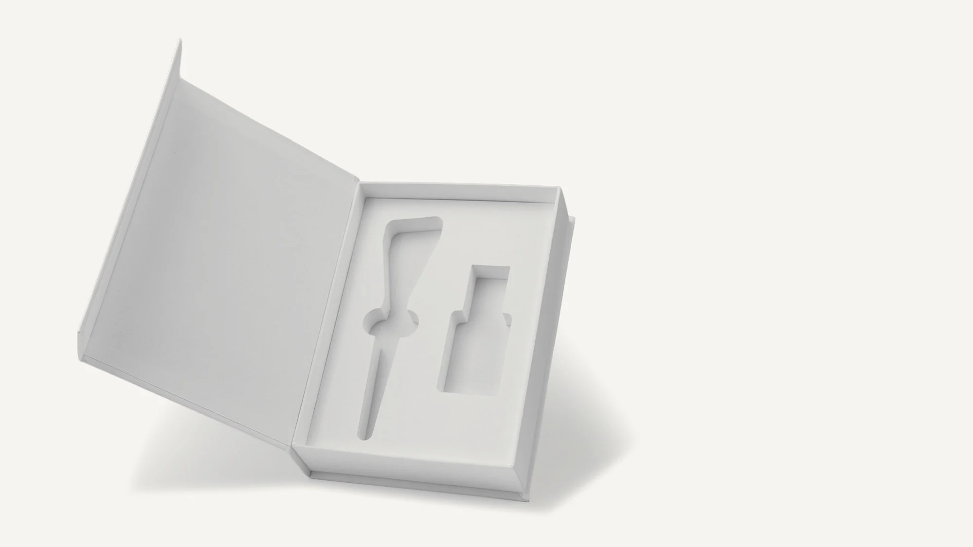 White rigid box, open, with a fitted insert